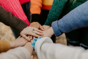 Diverse group of people holding hands