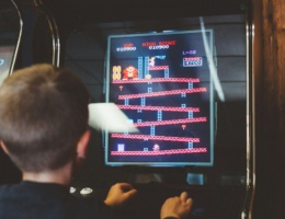 Kid playing video games in a games parlour| Play area for kids in Chennai