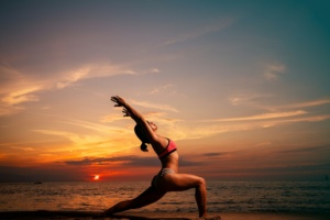 woman-doing-yoga-by-the-beach